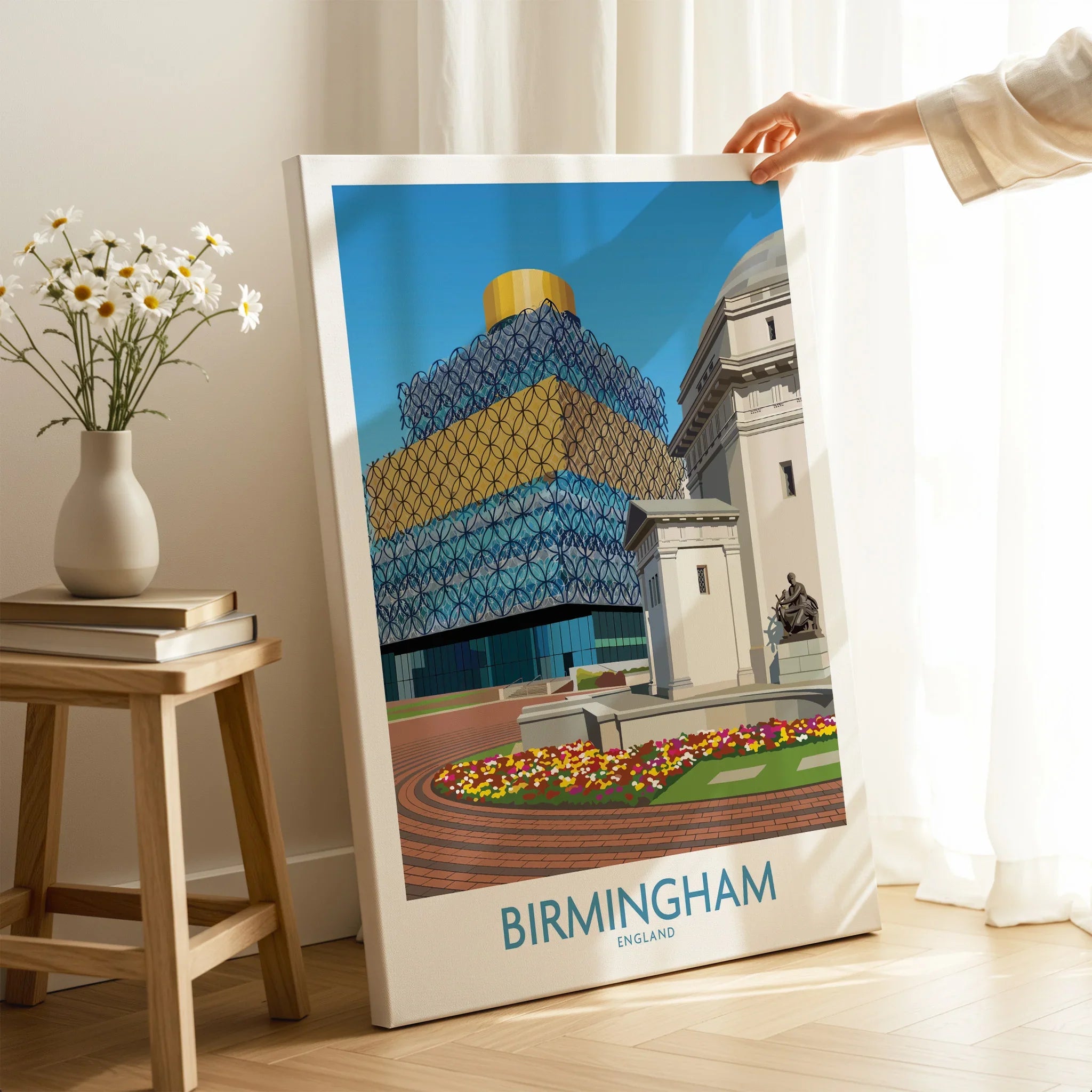Hand holding Birmingham England cityscape canvas print in cozy home decor setting