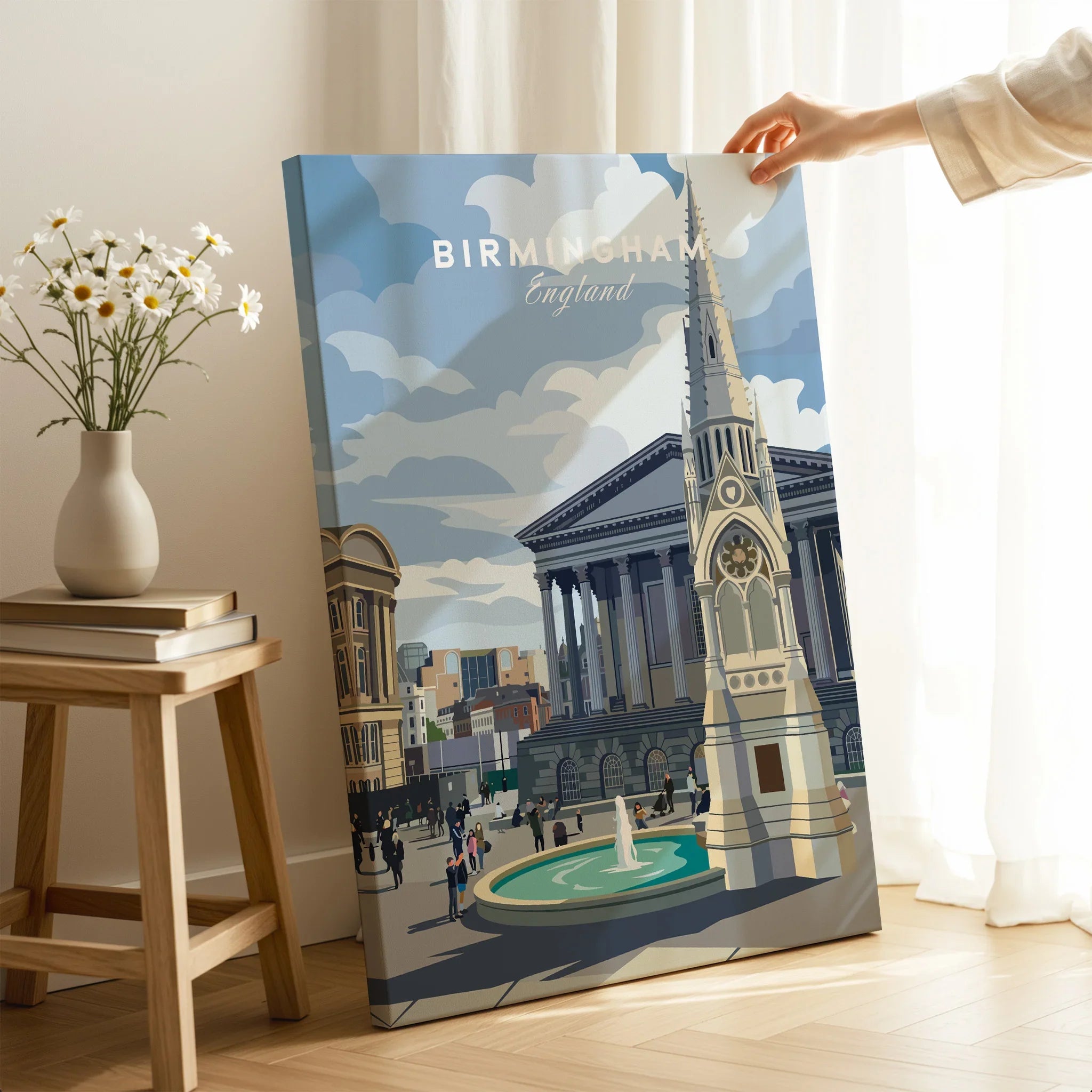 Hand holding Birmingham cityscape canvas wall art with historic buildings and fountain in modern room