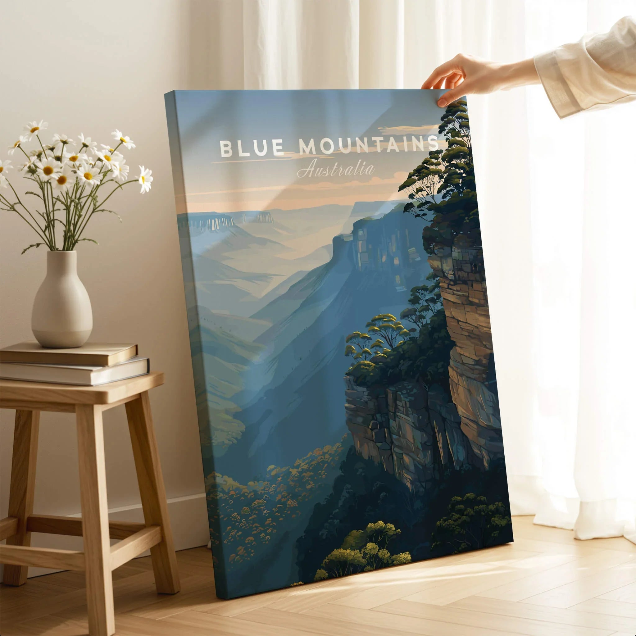 Blue Mountains Australia wall art canvas print with cliffs, held by hand in cozy room setting
