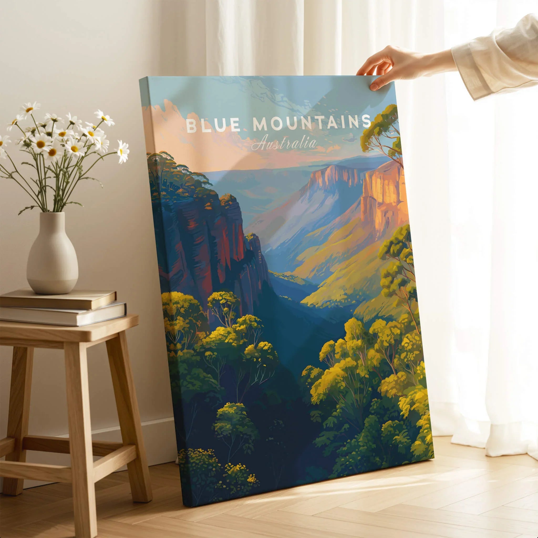 Hand holding Blue Mountains Australia travel poster canvas print in cozy room with flowers