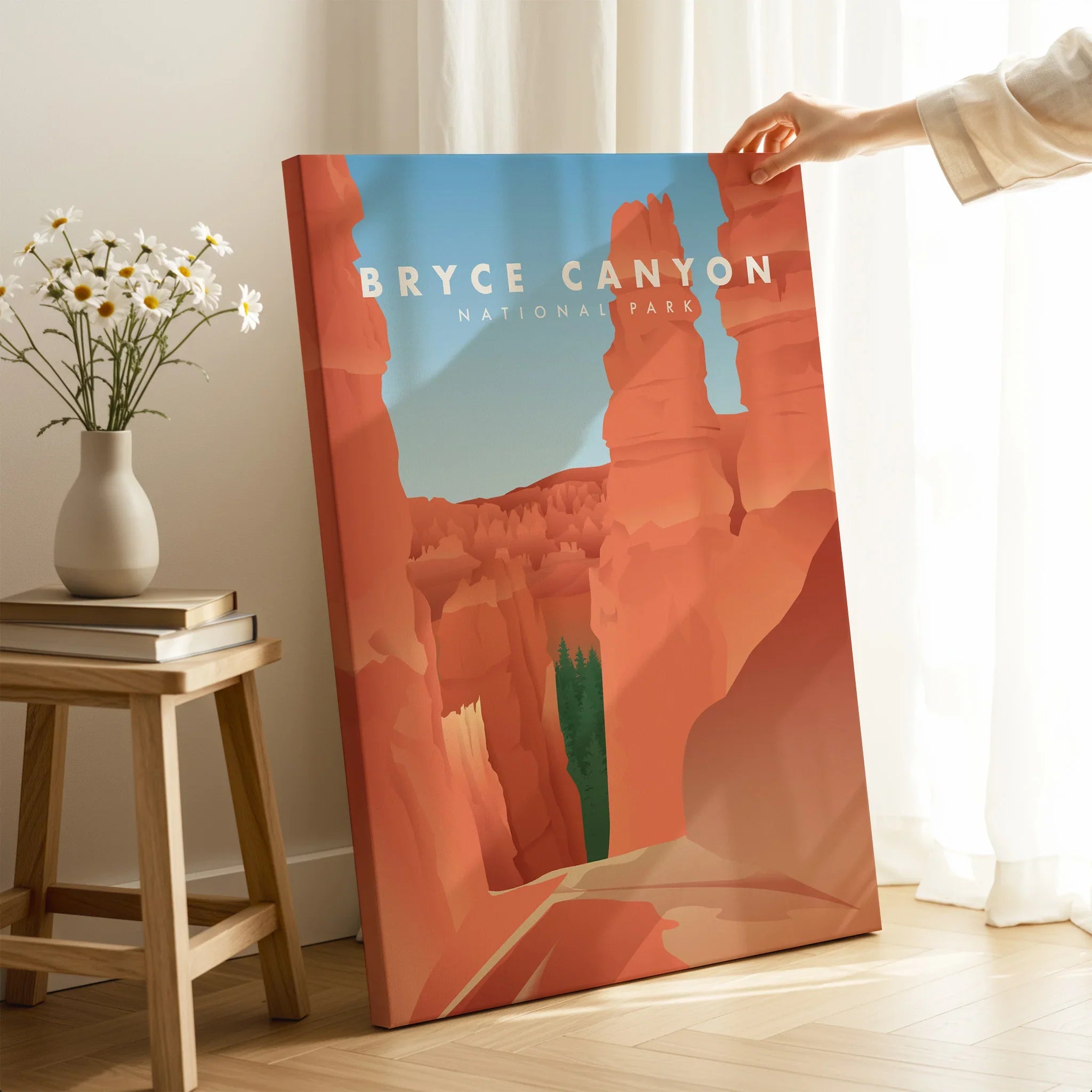 Hand holding Bryce Canyon National Park canvas print in modern sunlit room, travel wall art