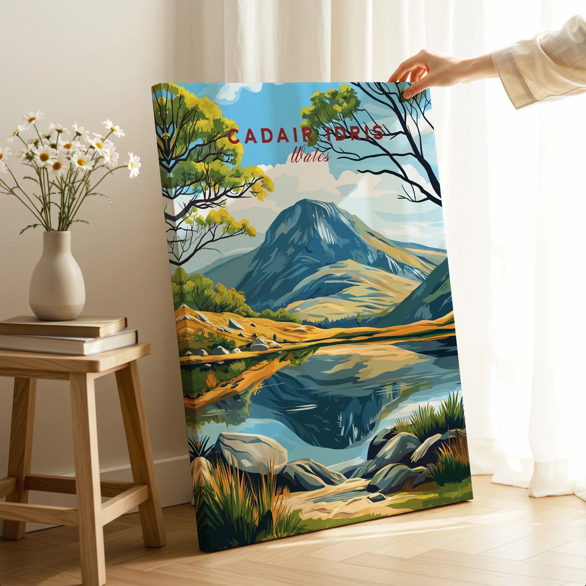 Hand holding a canvas print of Cadair Idris Wales landscape, modern home decor setting