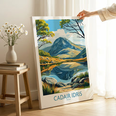Person holding Cadir Idris Wales travel poster canvas print in bright modern room.