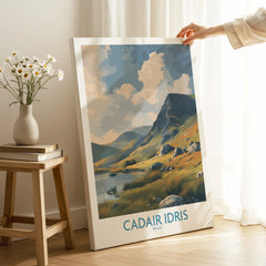 Hand holding a canvas print of Cadair Idris Wales landscape art in a bright room