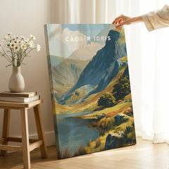 Hand holding a canvas print of a scenic Cadair Idris landscape, room with natural decor