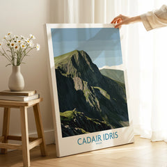 Hand holding canvas print of Cadair Idris Wales mountain art in bright room, modern decor