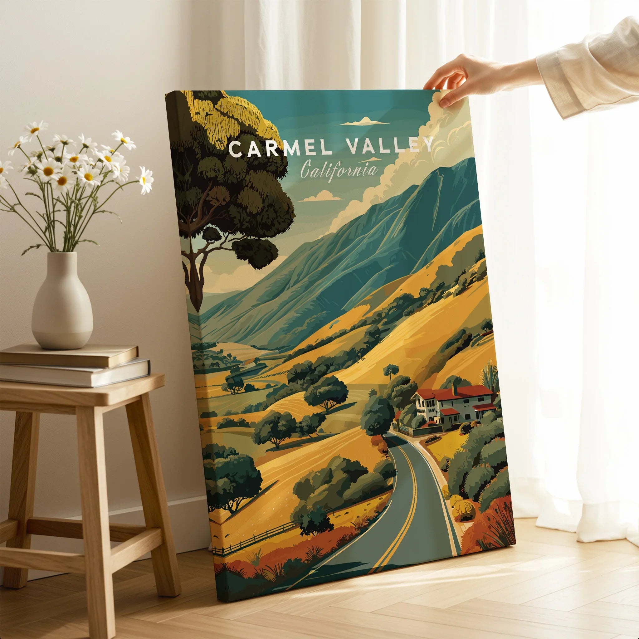 Hand holding Carmel Valley California canvas print with scenic landscape in cozy room