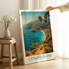 Hand holding Catalina Island travel poster canvas print with ocean, palm trees, and boats.