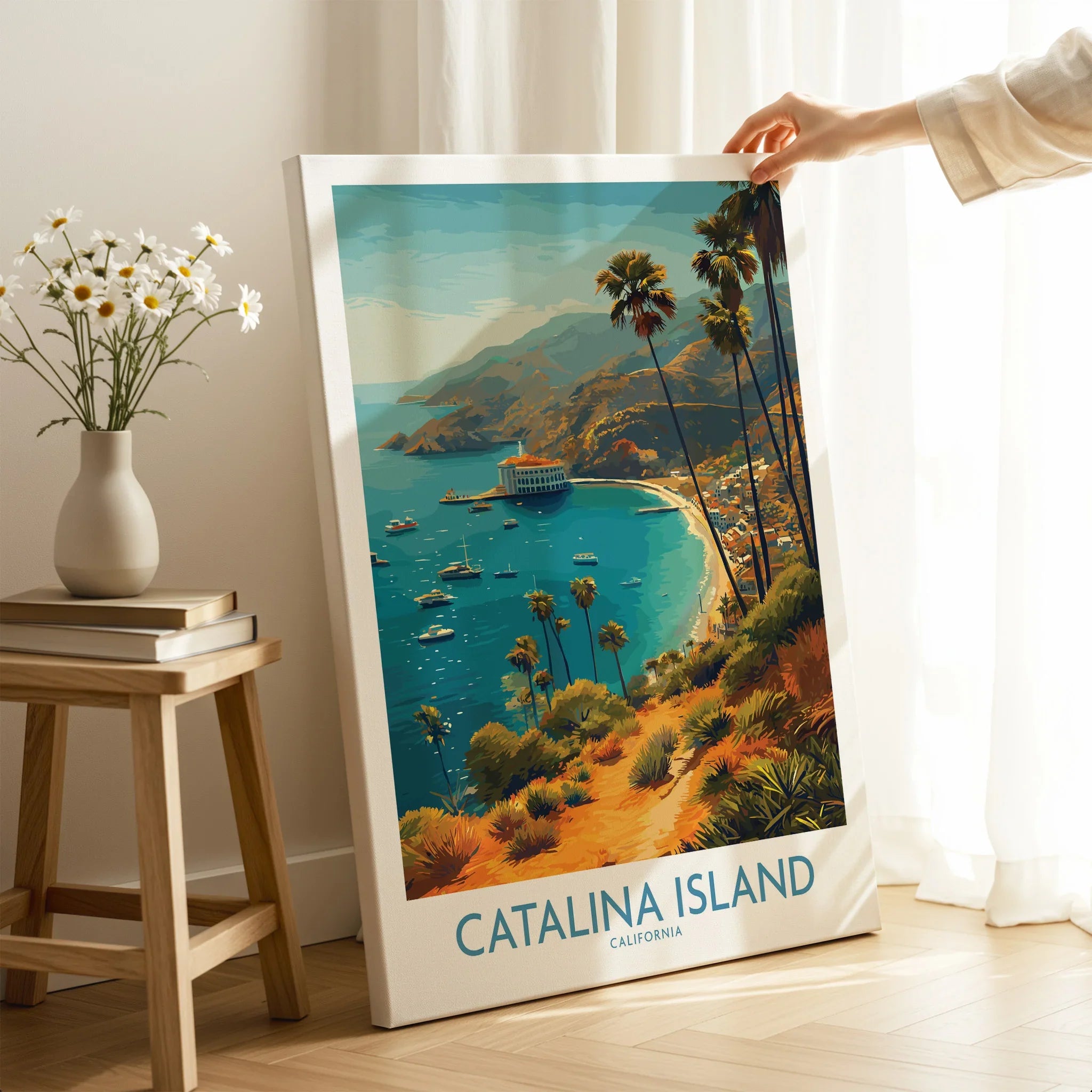 Hand holding Catalina Island travel poster canvas print with ocean, palm trees, and boats.