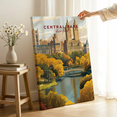 Hand holding Central Park New York canvas print with autumn cityscape and bridge, home decor