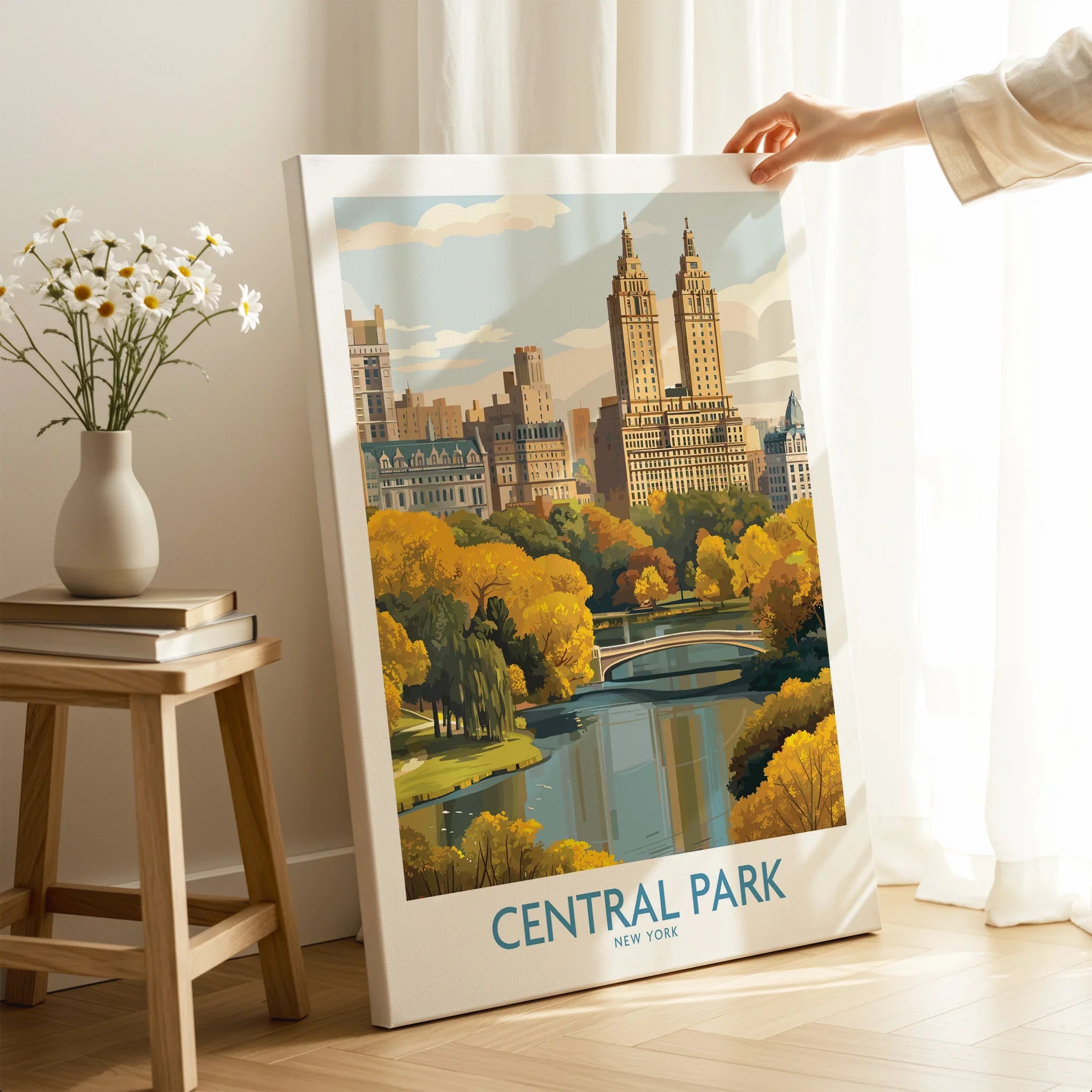 Hand holding Central Park New York canvas print in cozy room, skyline and bridge artwork