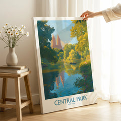 Hand holding Central Park canvas wall art with skyline and lake, in bright room decor setting.