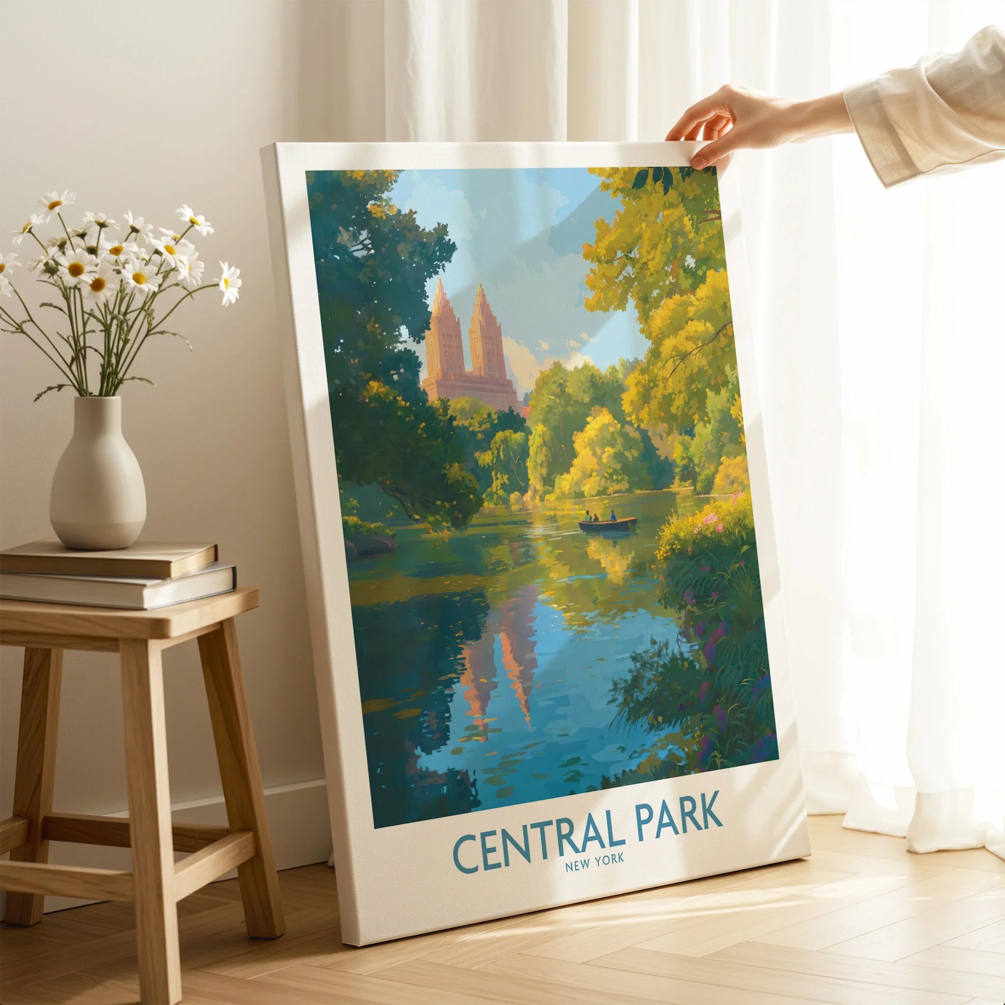 Hand holding Central Park canvas wall art with skyline and lake, in bright room decor setting.