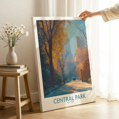 Hand holding Central Park New York canvas wall art with autumn trees in a cozy room
