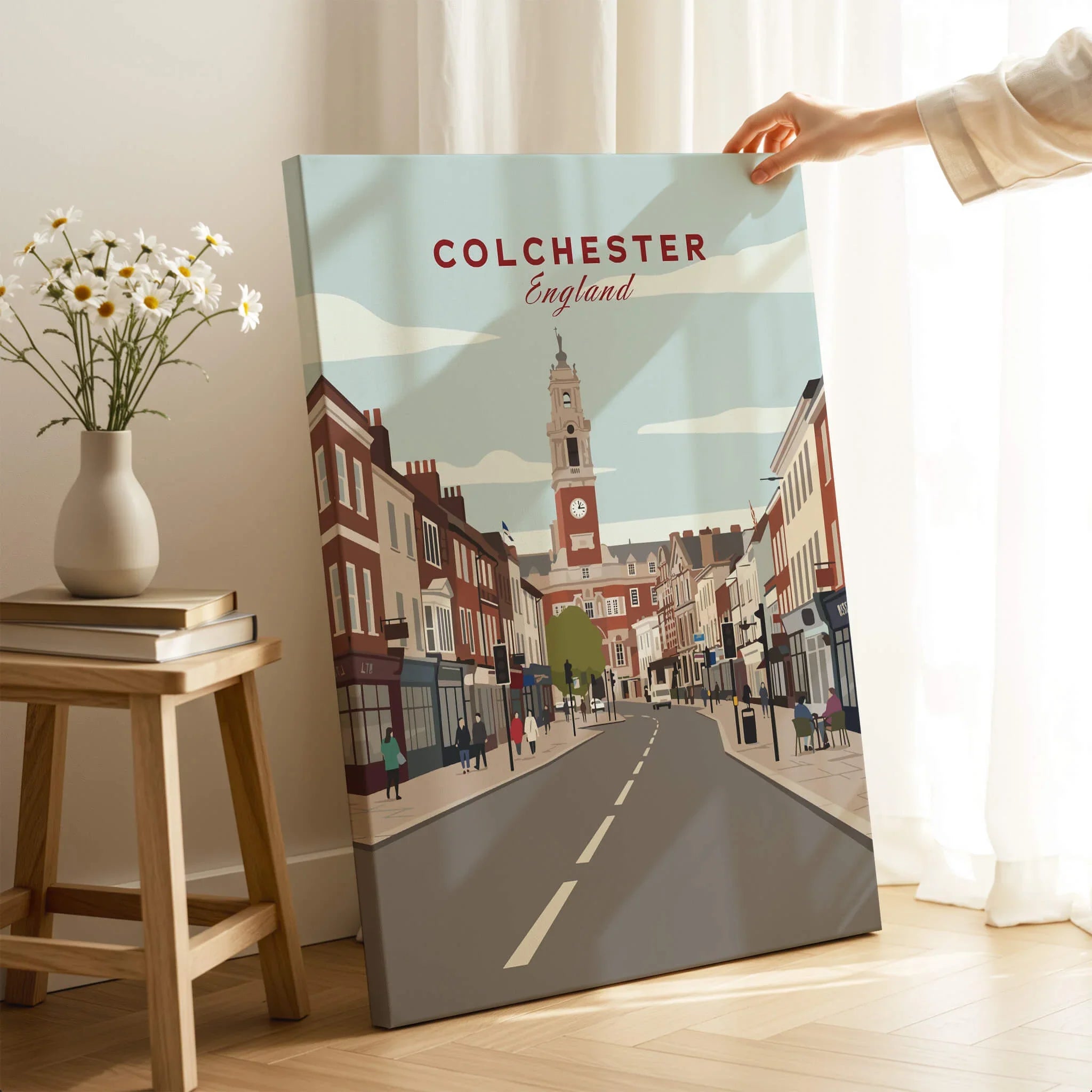 Colchester England travel poster canvas print with city street art, hand holding it in cozy room