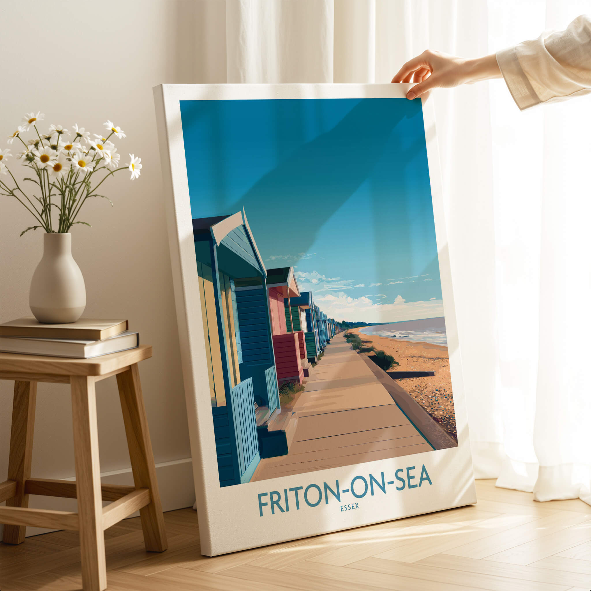Frinton-on-Sea England Wall Art – Colorful Seaside Beach Hut Decor Print displayed in a cozy room with flowers.