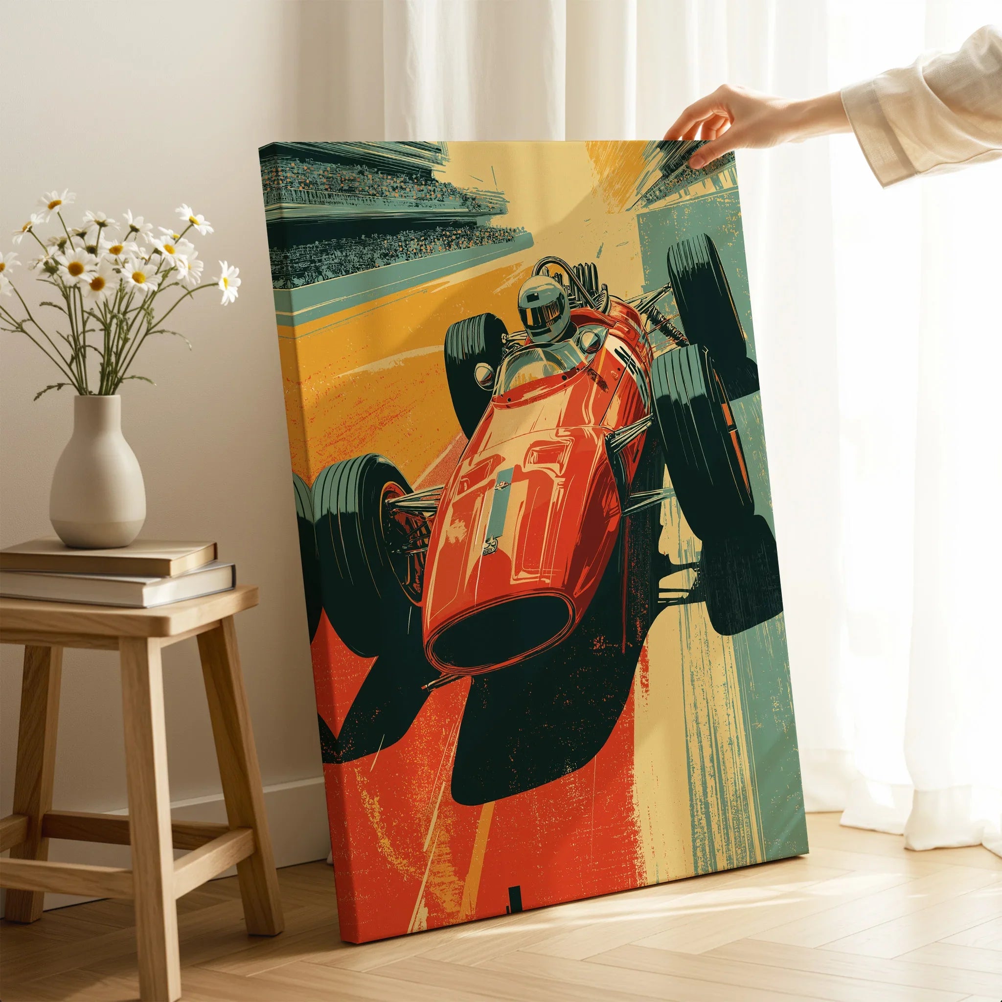 Hand holding vintage race car wall art canvas in modern room with flowers and books