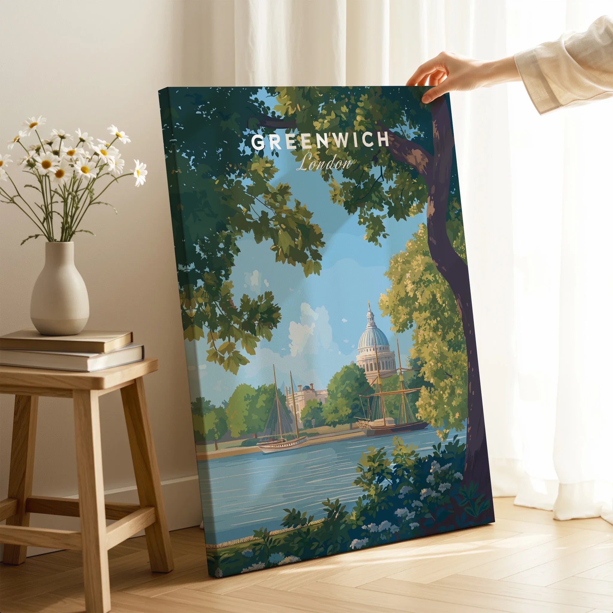 Hand holding Greenwich London travel poster canvas print in cozy room with vase of flowers