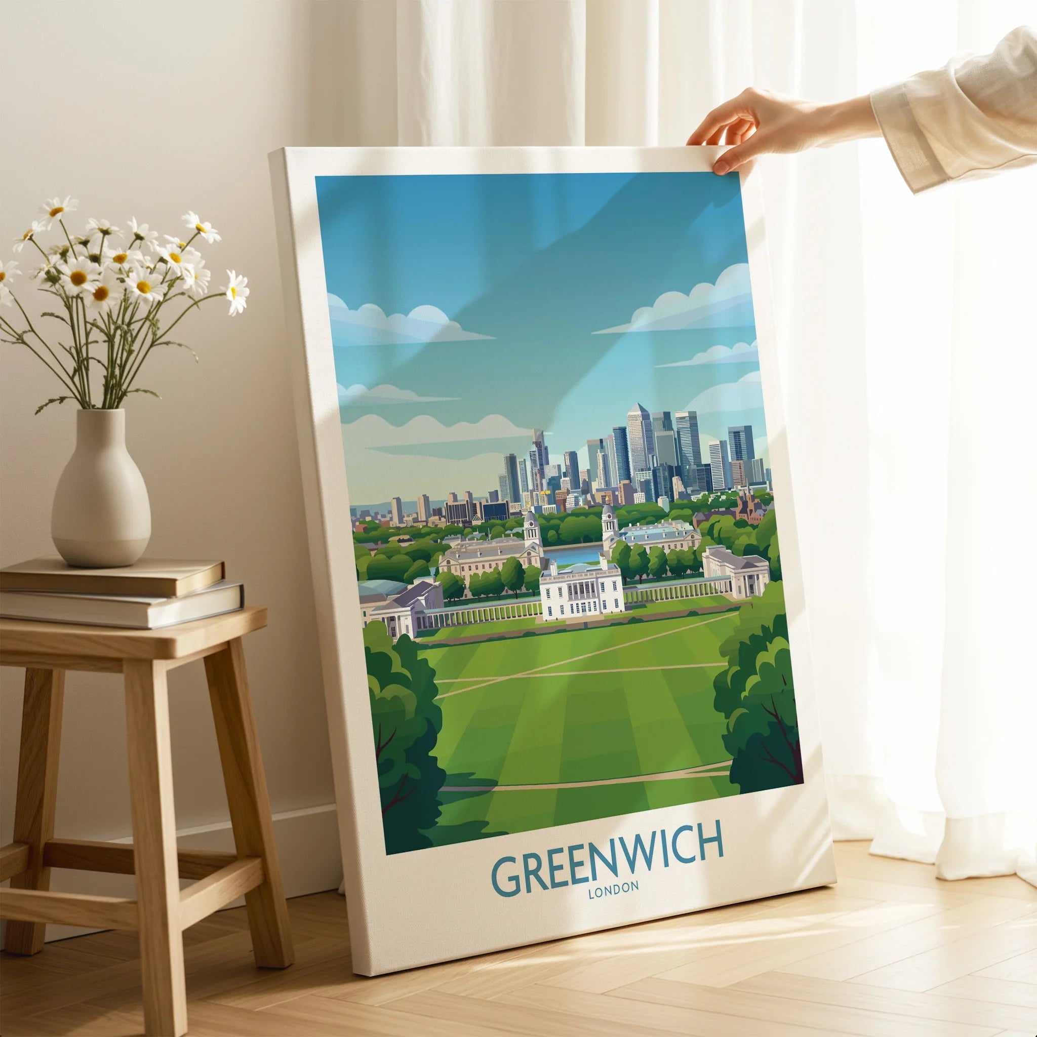 Hand holding Greenwich London travel poster canvas print in modern room setting