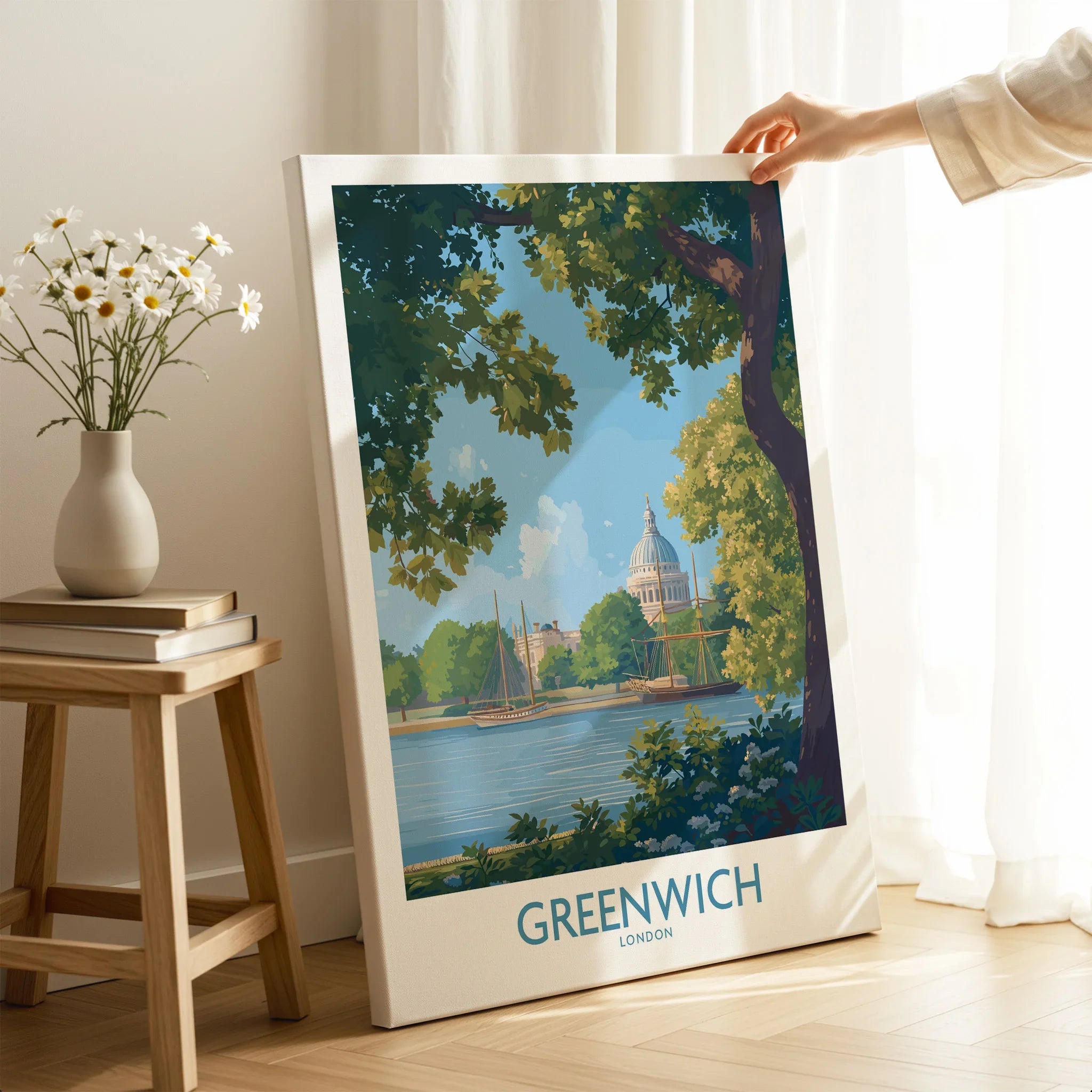 Greenwich London travel poster canvas print in sunlit modern room with hand holding edge
