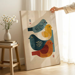 Modern Japanese-style canvas wall art with colorful abstract birds, hand holding print in bright room