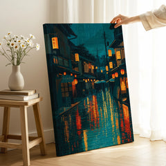 Hand holding canvas print of a rainy Japanese street with lanterns, for home wall decor