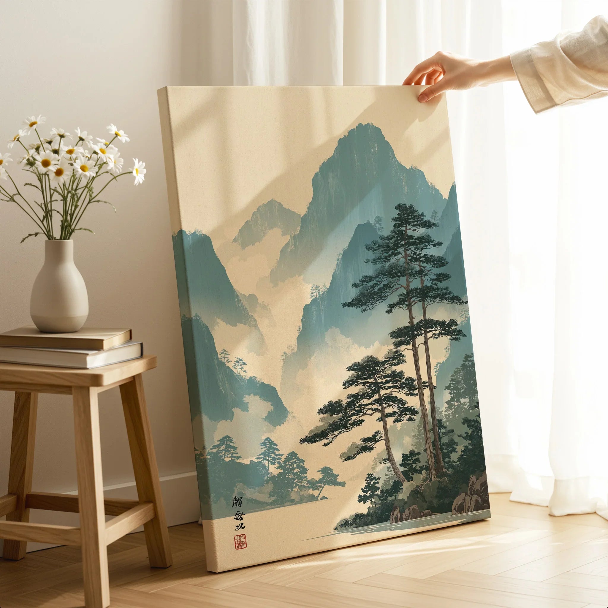 Hand holding Japanese woodblock mountain landscape canvas print in modern room decor