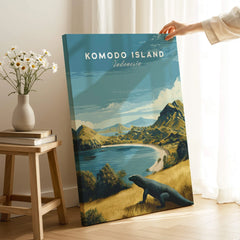 Hand holding Komodo Island travel poster canvas print with scenic landscape and Komodo dragon