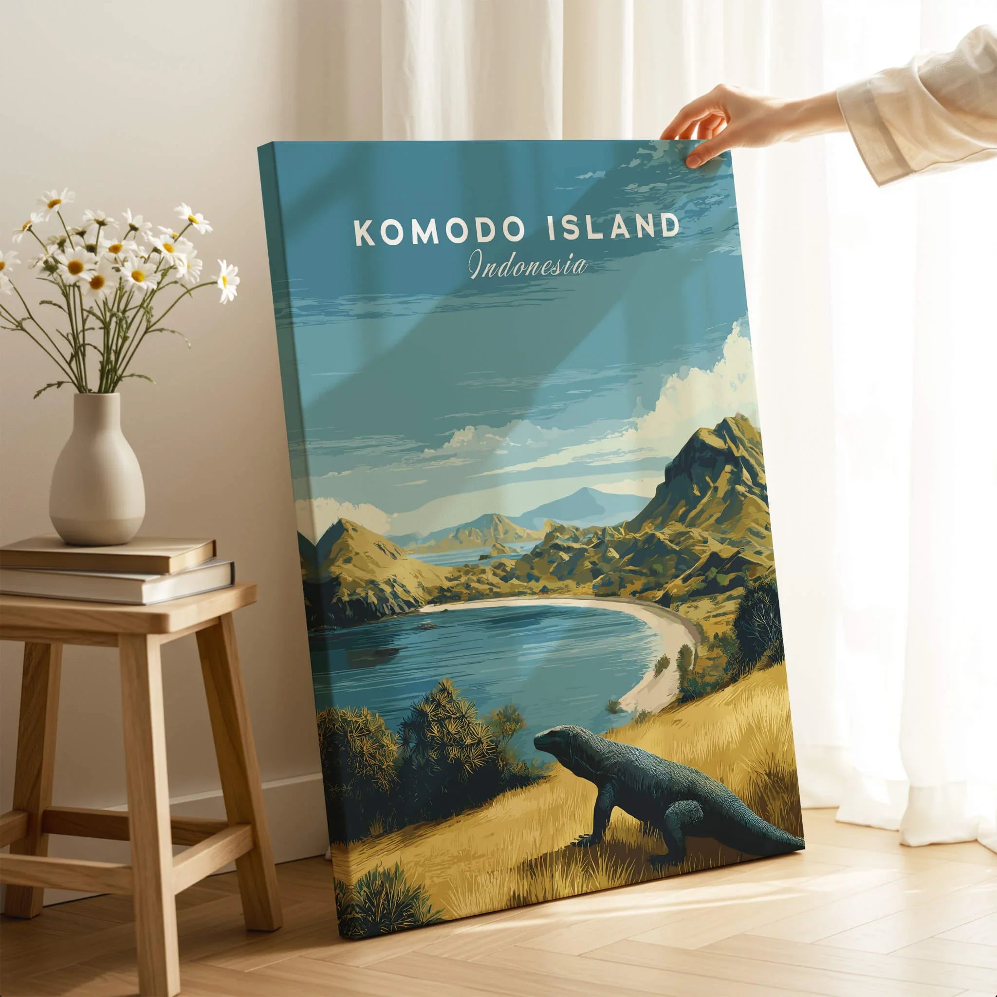 Hand holding Komodo Island travel poster canvas print with scenic landscape and Komodo dragon
