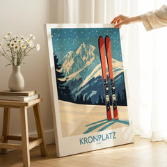 Hand holding canvas print of Kronplatz Italy ski travel poster with mountains and skis in cozy room setting