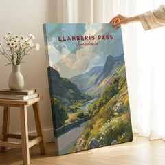 Hand holding Llanberis Pass Snowdonia canvas print in modern room with daisies and books