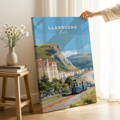 Llandudno Wales travel poster canvas print with vintage tram, held in sunlit room.