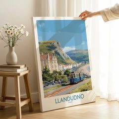 Llandudno travel poster canvas print with vintage tram, held in bright modern room