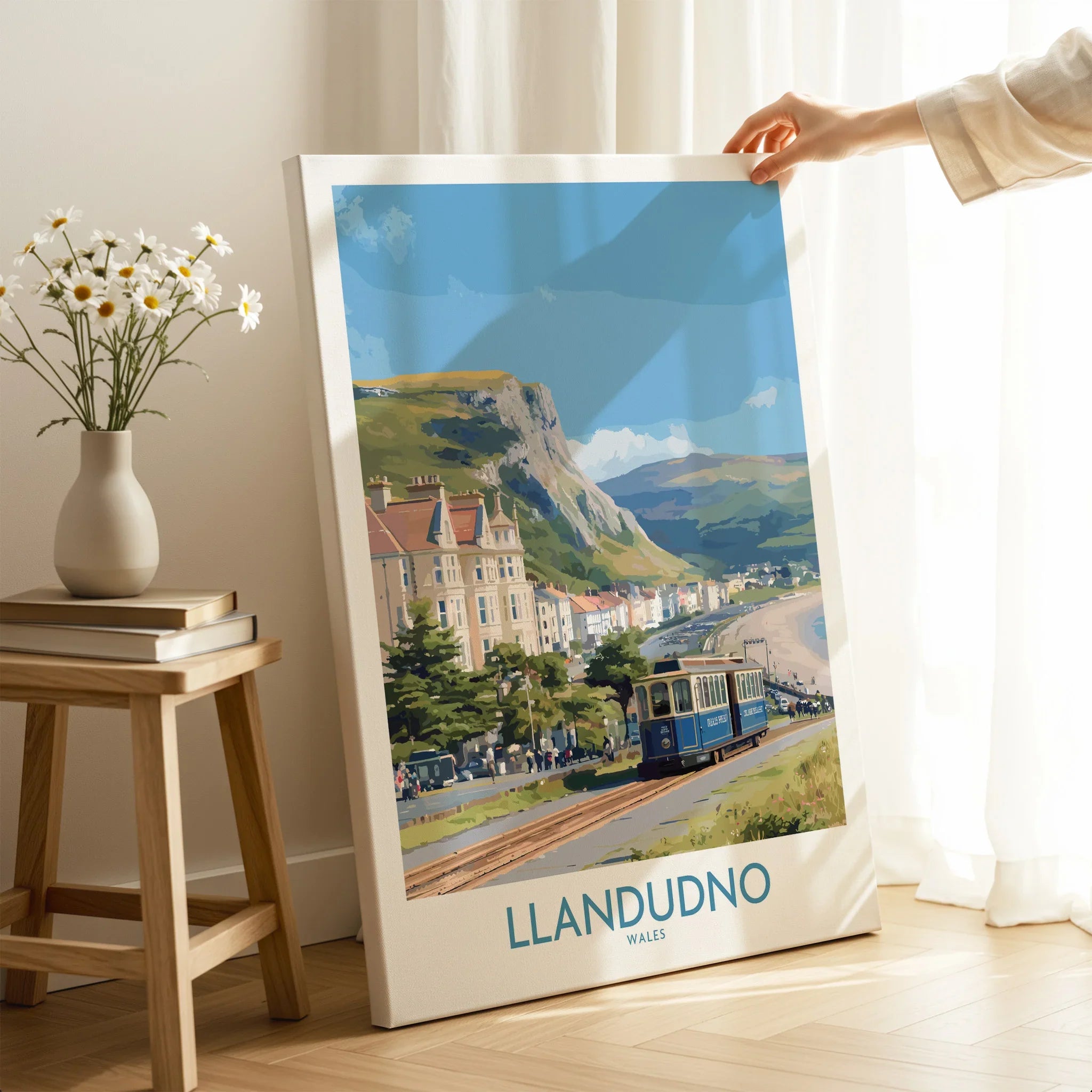 Llandudno travel poster canvas print with vintage tram, held in bright modern room