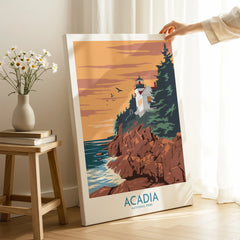 Acadia National Park canvas wall art featuring a lighthouse, cliffs, and ocean at sunset, held in a cozy room.