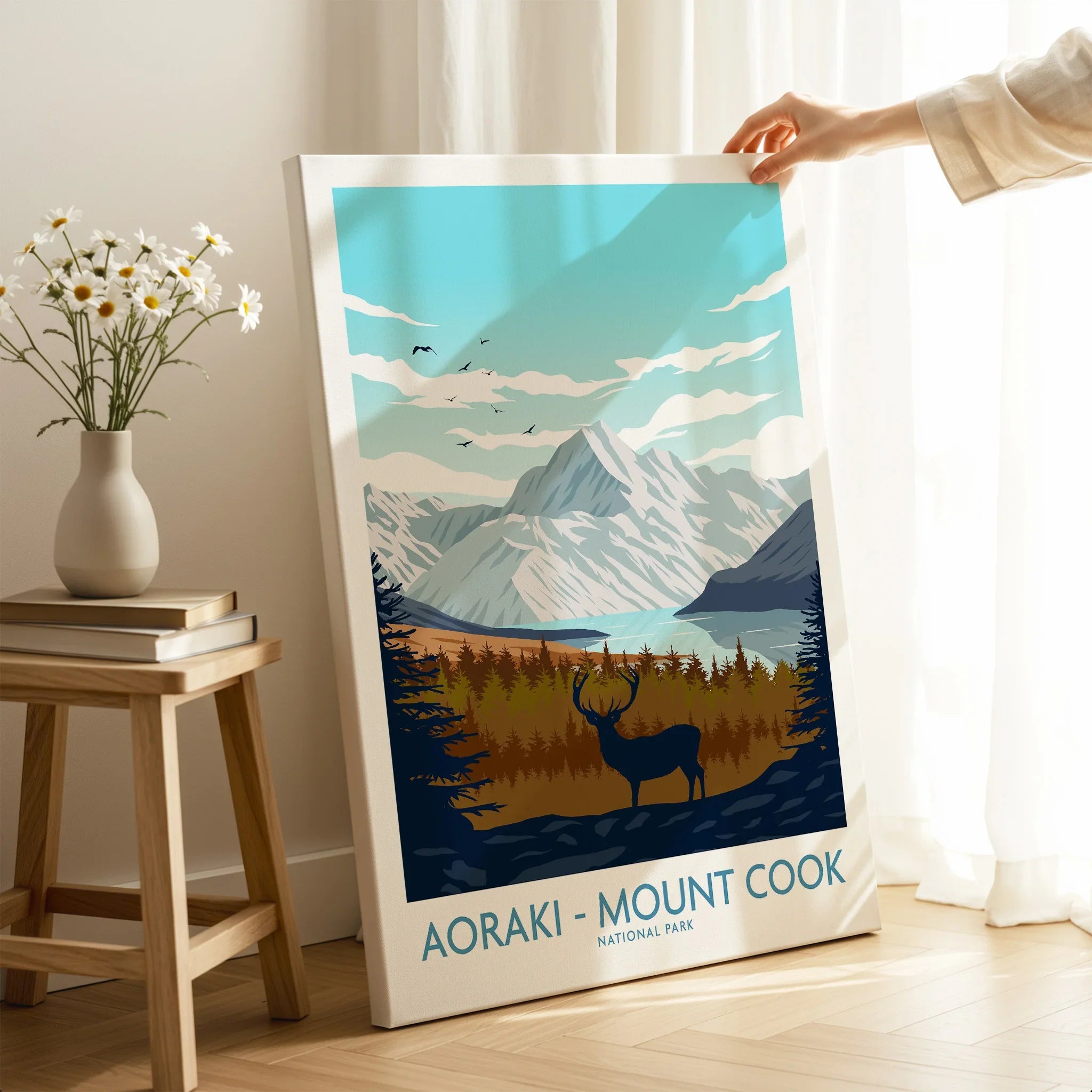 Hand holding Aoraki Mount Cook National Park travel poster canvas in modern home decor setting