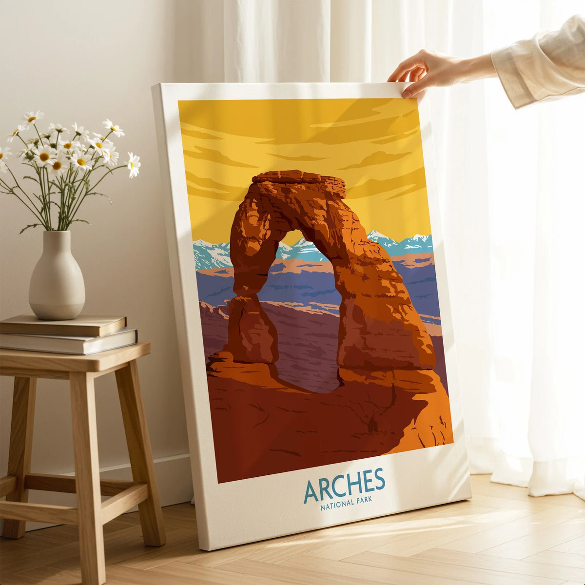Hand holding Arches National Park canvas print with Delicate Arch, modern home decor