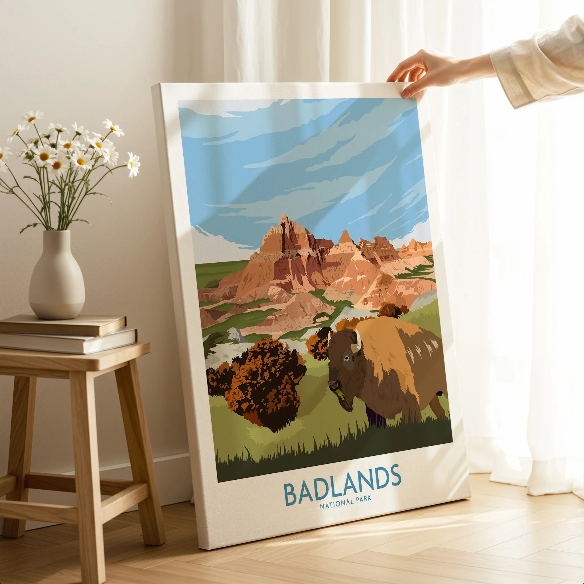 Hand holding Badlands National Park canvas print featuring bison and scenic landscape, home decor