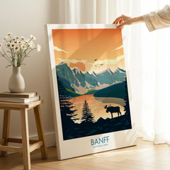 Hand holding Banff National Park canvas print with mountain and lake art in a cozy room