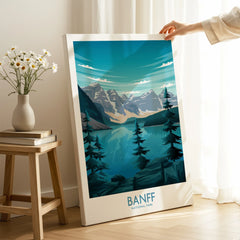 Hand holding a Banff National Park canvas print with mountains and lake in modern room
