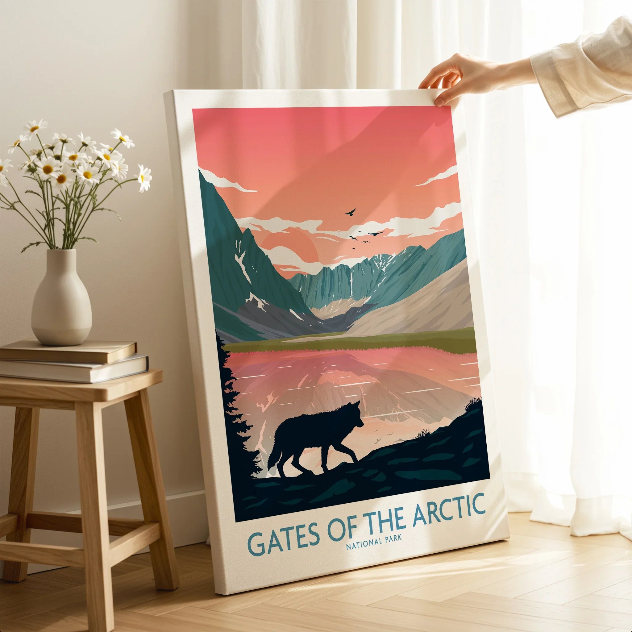 Hand holding Gates of the Arctic National Park canvas print featuring a wolf and mountain landscape.