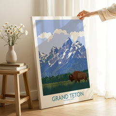 Hand holding Grand Teton National Park canvas print with bison and mountains in sunlit room