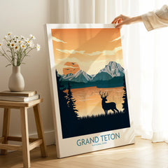 Hand holding Grand Teton National Park canvas print with sunset mountains and deer silhouette