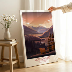 Loch Lomond canvas wall art print with scenic mountains, trees, and a Highland cow in a cozy room.
