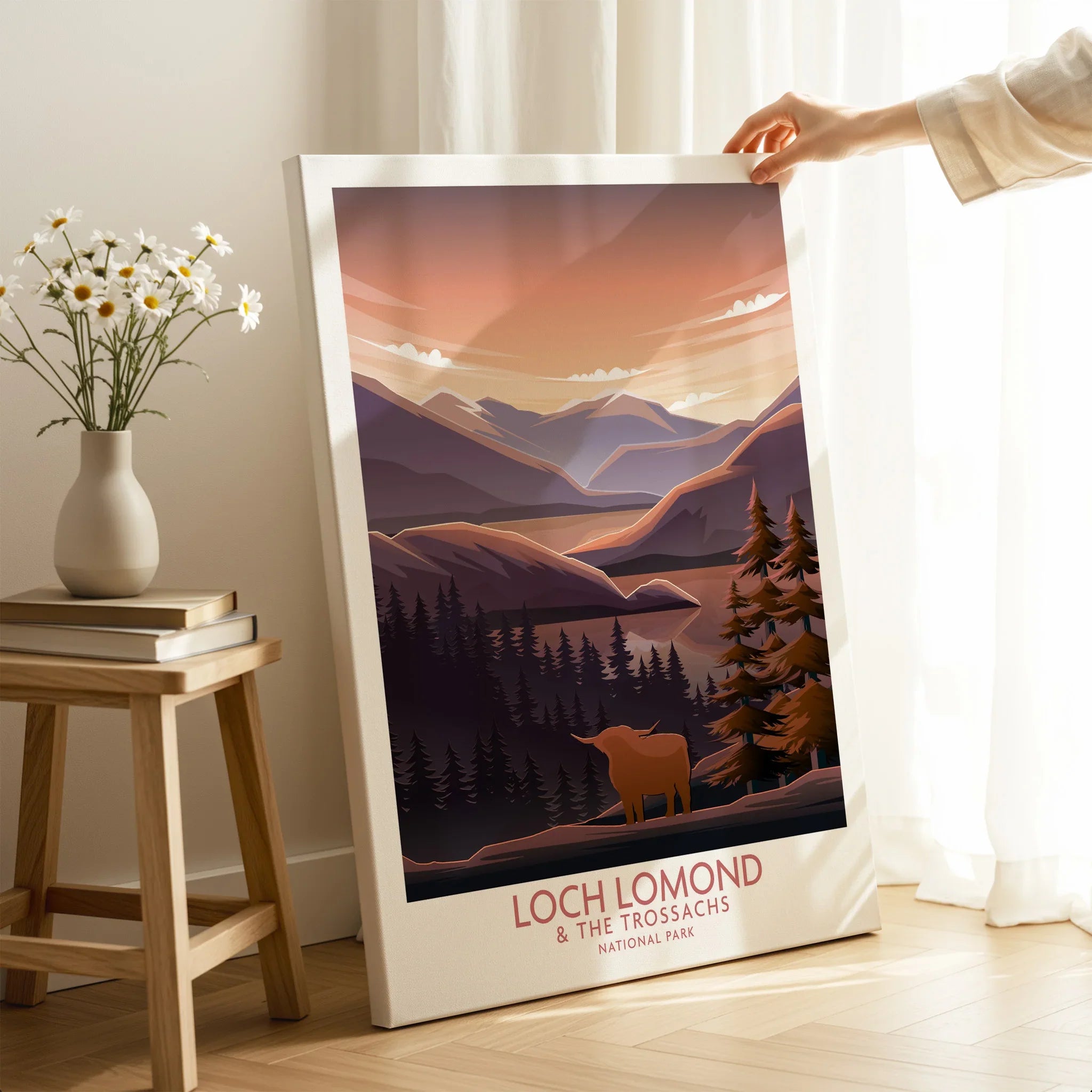 Loch Lomond canvas wall art print with scenic mountains, trees, and a Highland cow in a cozy room.