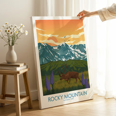 Hand holding Rocky Mountain National Park canvas print with elk and mountain art in room