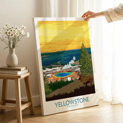 Hand holding Yellowstone National Park canvas print with colorful landscape in bright room