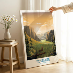 Hand holding Yosemite National Park canvas print with mountain and forest art in a cozy room