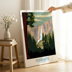 Hand holding Yosemite National Park canvas print with waterfall and forest in bright room