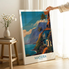 Hand holding Madeira Portugal travel poster canvas print with coastal landscape in bright room